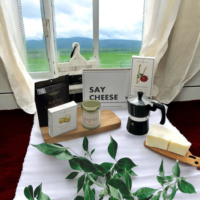 Box of cutting knives, cheese, crackers, popcorn, espresso machine and marble cutting board. Makes a great housewarming basket. Ships nationwide from NY.