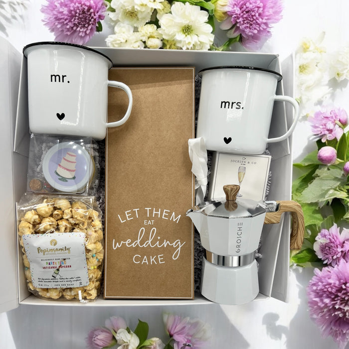 Wedding gift box filled with Mr. & Mrs. Mugs, cutting cake knife, espresso machine, wedding candle and champagne bubble candies. Ships nationwide from NYC.