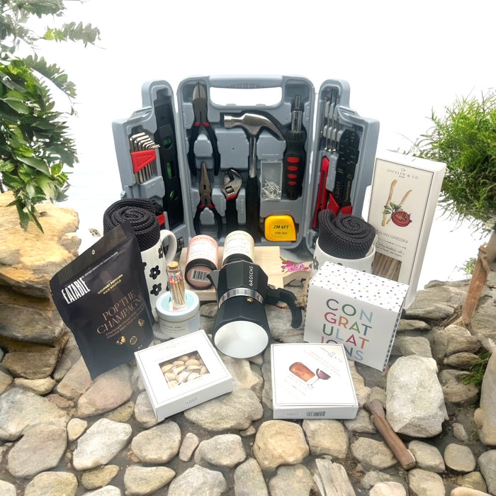 Housewarming Gift Basket filled wih took kit, espresso machine, popcorn, crackers, teas, nuts, cheese, congrats cookies, mut, candle and dish rag. Shipped nationwide from NYC