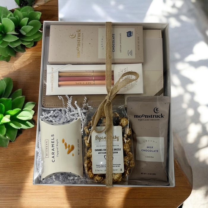 Gourmet Gift Box filled with artisan chocolate bar, vegan leather journal with pens, caramel popcorn, caramels and hot cocoa. Ships nationwide from NYC