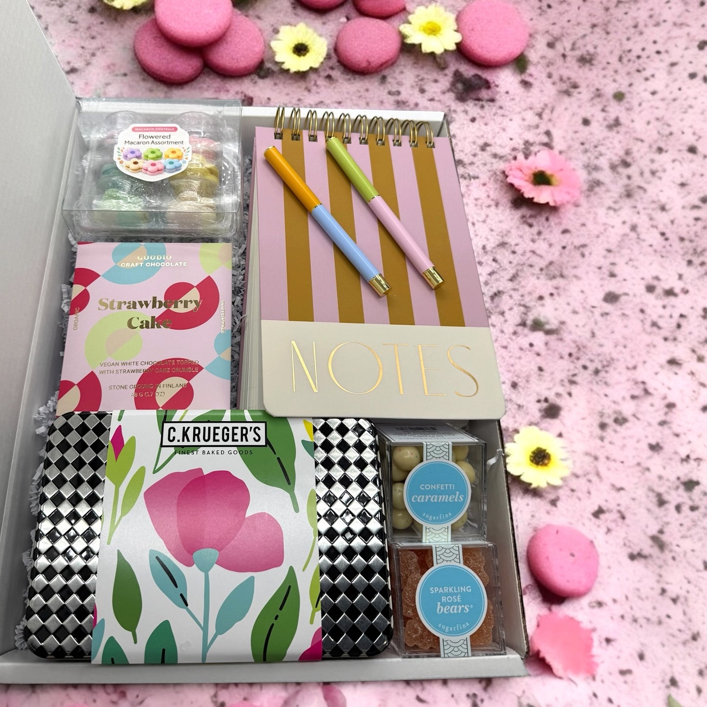 Gift box containing note pad, pens, floral macarons & cookies, sugarfina candies & strawbery cake bar.
