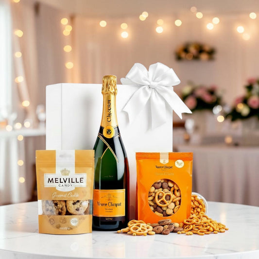 Veuve Clicquot champagne with chocolate covered cookies and pretzels in a white luxury gift box — premium corporate holiday gift basket