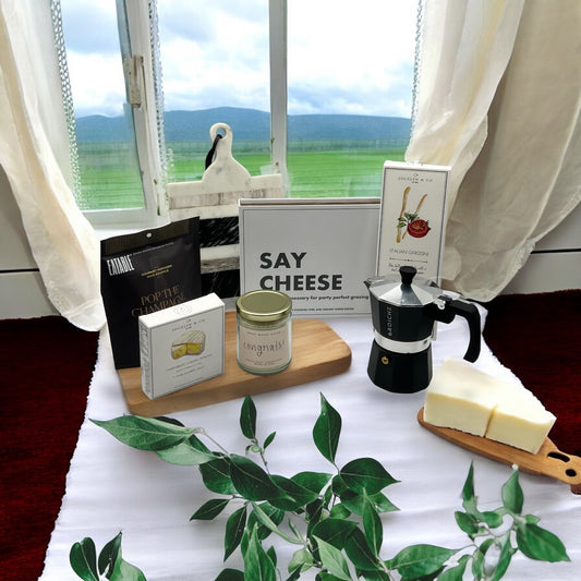 Box of cutting knives, cheese, crackers, popcorn, espresso machine and marble cutting board. Makes a great housewarming basket. Ships nationwide from NY.