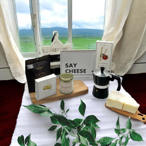 Box of cutting knives, cheese, crackers, popcorn, espresso machine and marble cutting board. Makes a great housewarming basket. Ships nationwide from NY.