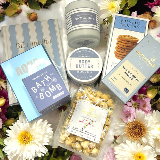 Relaxation gift basket featuring artisan chocolate, bath products, Be Mindful Journal, popcorn, and chocolate chip cookies. Ships nationwide from NYC.