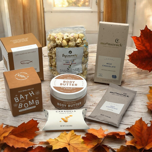 Gourmet gift box containing oatmeal spa products, gourmet popcorn, artisan chocolates, caramels, and hot cocoa.