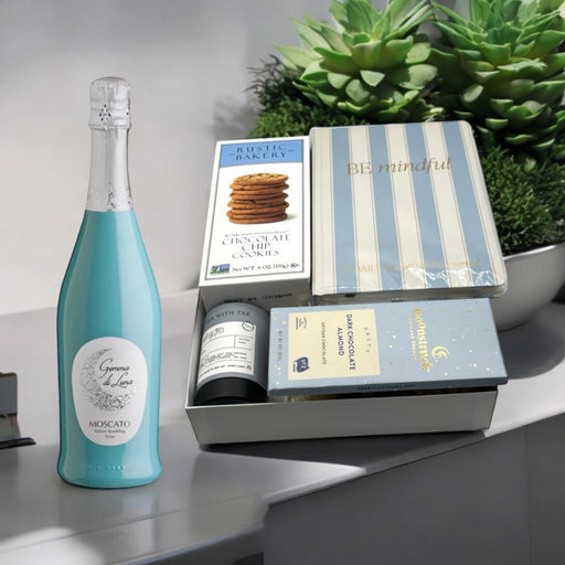 Gift set featuring sparkling wine, a journal, gourmet tea, cookies, artisan chocolate; perfect for all occasions and holidays
