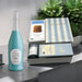 Gift set featuring sparkling wine, a journal, gourmet tea, cookies, artisan chocolate; perfect for all occasions and holidays