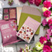 Gourmet gift basket with popcorn, artisan chocolates, and a vegan leather journal, perfect for all occasions including Mother's Day.