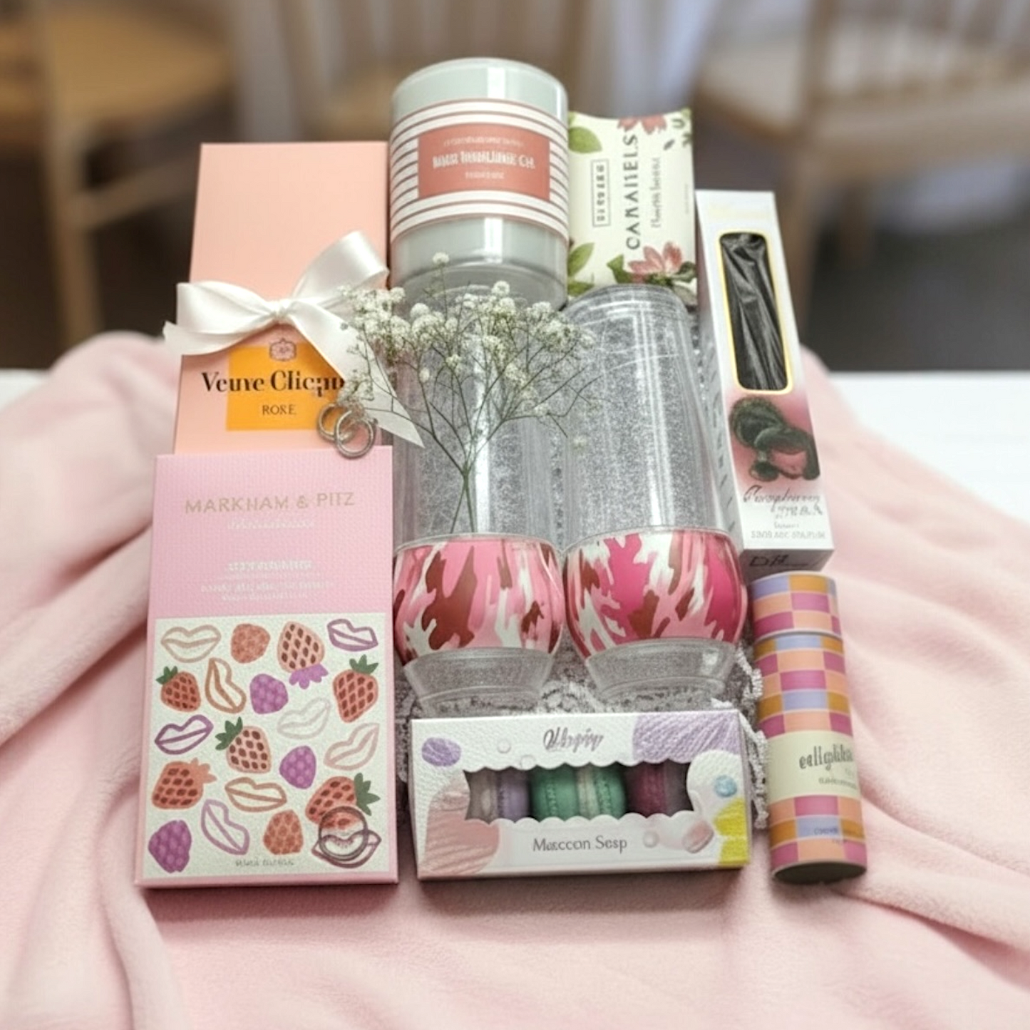 Collection of artisan chocolate bars, cooler flutes, Veuve Clicquot Rose Champagne, candle, matches, caramels & macaron shaped soaps