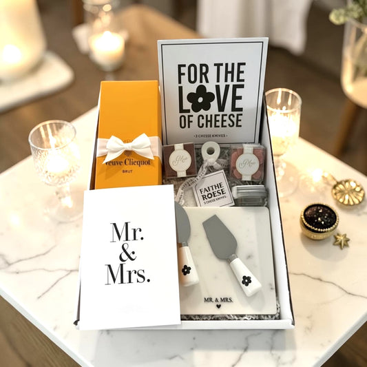 Veuve Clicquot Champagne with cheese utensils, Mr.& Mrs. marble cutting board & Mr. & Mrs. Sugarfina candies.