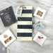 Housewarming gift includes marble cutting board with cheese, crackers, nuts, popcorn and house candle. Ships nationwide from NY.