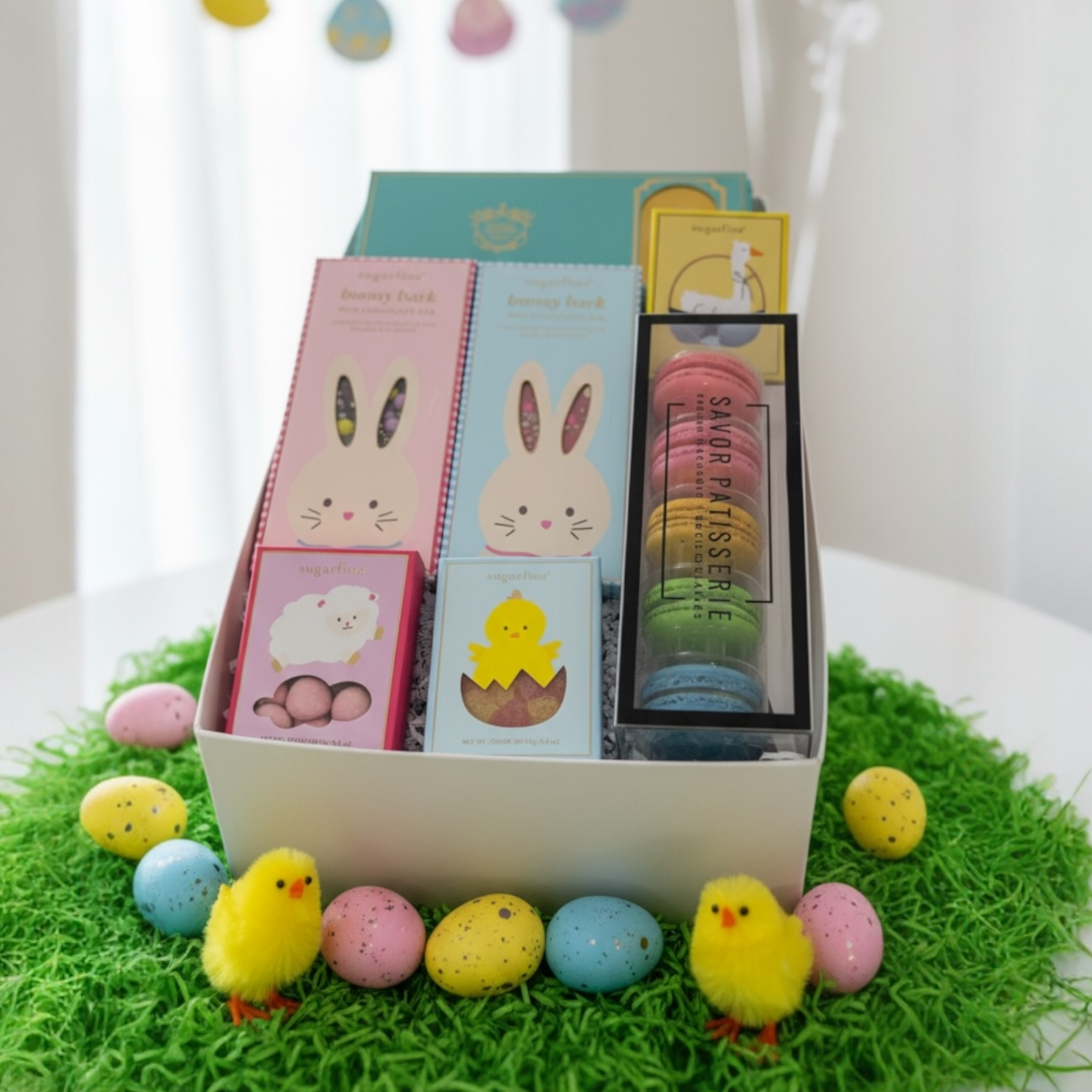 Easter candies, macarons & chocolates in gift box.