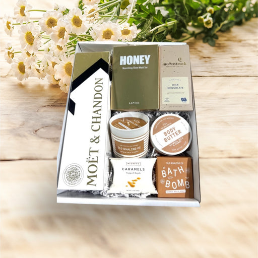 Gift box filled with Moet Brut Champagne, bath productss, artisan chocolates and caramels.
