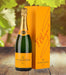 A bottle of Veuve Clicquot Champagne featuring its iconic bright yellow label, known for its premium quality and rich flavors.